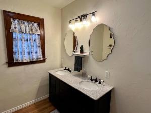 a bathroom with two sinks and a large mirror at The Ely Airbnb in Ely