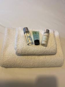 two bottles of cosmetics sitting on top of a towel at The Flat in central Kirkby Stephen in Kirkby Stephen