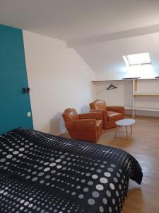 een slaapkamer met een bed en een woonkamer bij Maison proche du centre ville - Mitoyenne in Saint Die