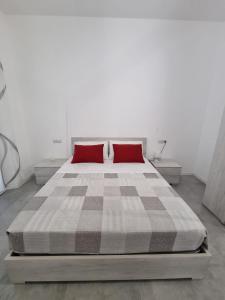 a bedroom with a large bed with red pillows at CASA VERDi 37 CAMERA RUBINO SMERALDO in Porto SantʼElpidio