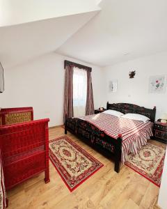 a bedroom with a large bed and a window at Pensiunea Sovirag in Sic