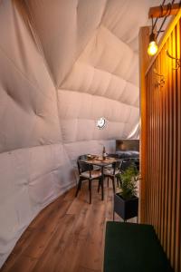 a dining room in a tent with a table and chairs at Glamping Idyllaglamp Loft in Dzbądzek