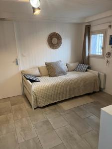 a large bed in a room with a tile floor at Logement ICARE 5km de Crolles, Soitec , ST in Lumbin