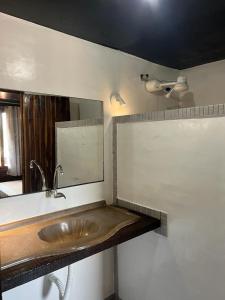 a bathroom with a sink and a mirror at Pousada Coral Negro in Jericoacoara