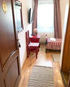 pokój z drzwiami, stołem i oknem w obiekcie Pensiunea Sovirag w mieście Sic