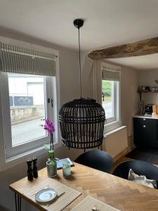 a dining room with a table and a pendant light at Rosehill Cottage 1699 - Stilvolle Ferien Berge & Seen 