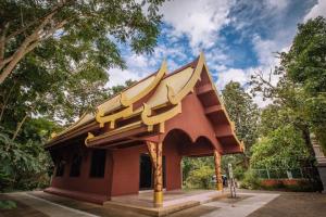 a small building with a roof in a park at The Living - Holiday Home Phayao in Phayao