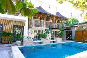 a villa with a swimming pool and a house at Urban Oasis Resort, Tarlac in Tarlac