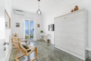 a living room with a large white sliding door at On The Port in Rafina