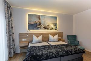 1 dormitorio con 1 cama y una pintura en la pared en Ferienapartments Pension Elsternest en Bad Liebenwerda