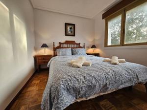 a bedroom with a large bed with two pillows on it at 303A Casa Elisa Cudillero in Cudillero