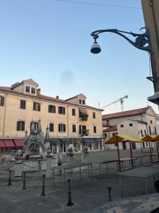 a city street with buildings and a street light at Collie’s place in Koper