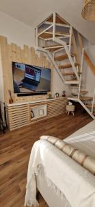 a bedroom with a bed and a tv in a room at Il rifugio di Claudia in Ovindoli