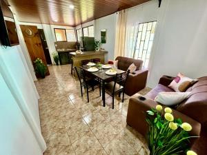 a living room with a couch and a table at Casa Tropical Ceiba in Puerto Jiménez