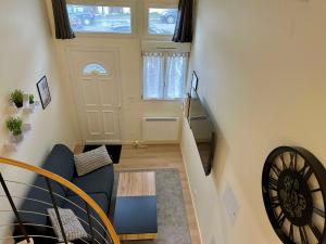 a living room with a staircase and a blue couch at Appartement Cosy et fonctionnel 4 personnes in Le Havre