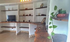 a room with a desk in a room with shelves at Amelí Alojamiento in Salta