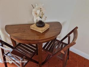 a wooden table with a vase on top of it at The Annexe in Bridlington