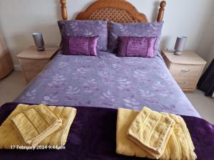 a bedroom with a purple bed with two night stands at The Annexe in Bridlington