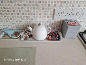 a tea kettle sitting on a counter with a box at The Annexe in Bridlington