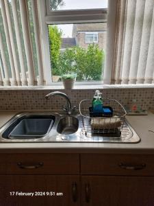 ein Waschbecken in einer Küche mit Fenster in der Unterkunft The Annexe in Bridlington