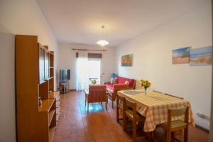 a living room with a dining room table and chairs at EastView Lagos in Lagos