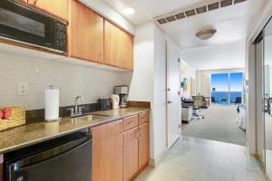 a kitchen with a sink and a microwave at Luxurious Resort Gym Balcony in Miami Beach