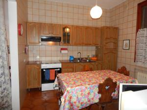 a small kitchen with a table and a stove at Ada home in Venice