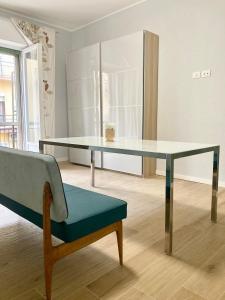a glass table and a chair in a room at "Il Garibaldi" - Appartamento intero o stanze! in Reggio di Calabria