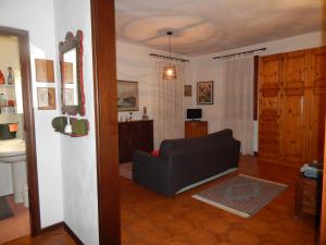 a living room with a black couch and a sink at Ada home in Venice