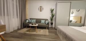a living room with a couch and a table at Confort Studio 1 City Center in Bucharest