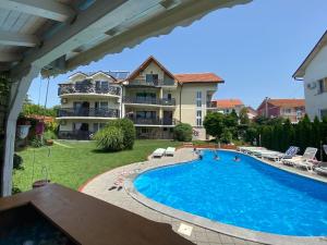 a swimming pool in front of a building at Smestaj Milovanovic in Soko Banja