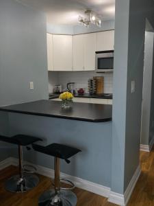 a kitchen with a counter and two stools in it at Condo in Downtown in Vancouver