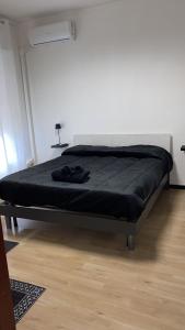 a bed in a bedroom with a black blanket on it at Red_Cross.Rent_Appartament in Palermo