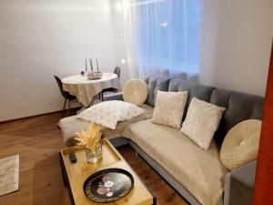 a living room with a couch and a table at Apartament Velana in Reşiţa