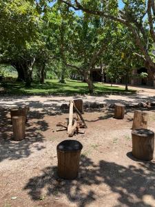 a group of logs in a park with trees at Villas Ecuestre Hotel Tepoztlán in Tepoztlán