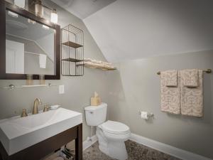 a bathroom with a white toilet and a sink at The Savannah, Boutique BNB & Spa in Lewes