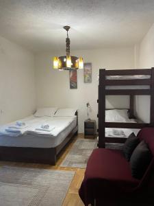 a bedroom with two beds and a bunk bed at Apartman sa terasom Vila Mina Kopaonik in Kopaonik