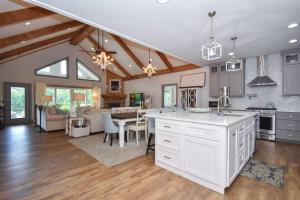 a kitchen and living room with a table and a dining room at Mallard Cove Sunsets Lake Martin in Dadeville