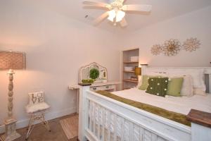 a bedroom with a bed and a ceiling fan at Mallard Cove Sunsets Lake Martin in Dadeville