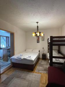 a bedroom with a bed and a bunk bed at Apartman sa terasom Vila Mina Kopaonik in Kopaonik