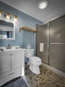 a bathroom with a white toilet and a shower at The Savannah, Boutique BNB & Spa in Lewes