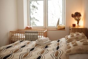 a bedroom with a bed with towels on it at Aleksandria nad Olzą in Istebna