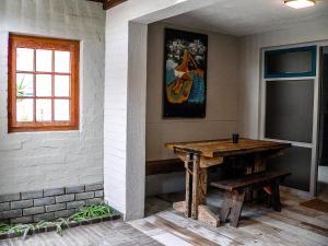 a room with a wooden table and a painting on the wall at de Baken Self-Catering in Walvis Bay