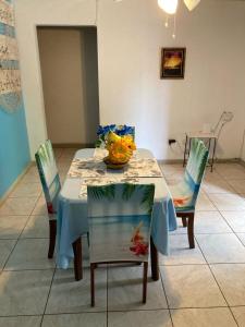 a dining room table with chairs and a vase on it at Fairmont in Negril