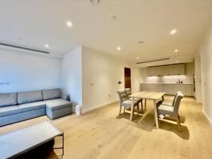 sala de estar con sofá, mesa y sillas en Modern apartment in heart area en Londres