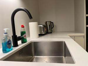 a kitchen counter with a sink in a kitchen at Modern apartment in heart area in London