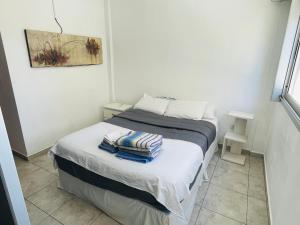 een kleine slaapkamer met een bed met handdoeken erop bij Departamento 13 y 59 in La Plata