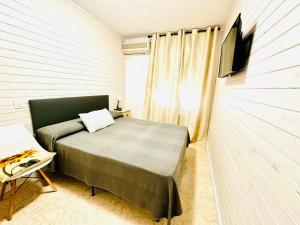 Postel nebo postele na pokoji v ubytování Hostal La Taberna