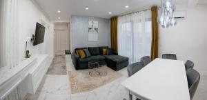 a living room with a couch and a table at Oasului Residence in Cluj-Napoca