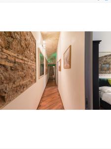 a hallway in a house with a stone wall at Bretone XI b&b in Rome